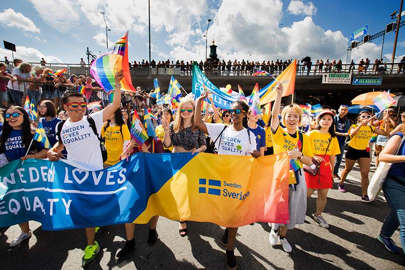 People at a pride parade with t-shirts and banners from the toolkit.