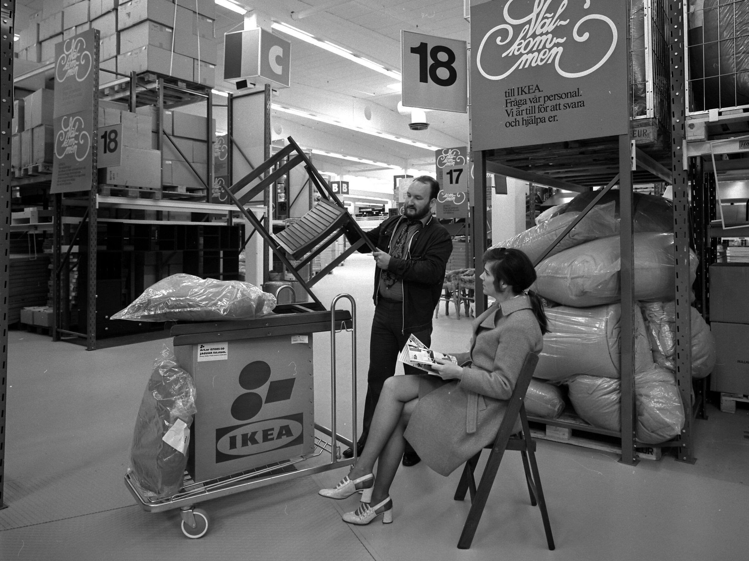 A couple in the sixties collecting furniture at IKEA.