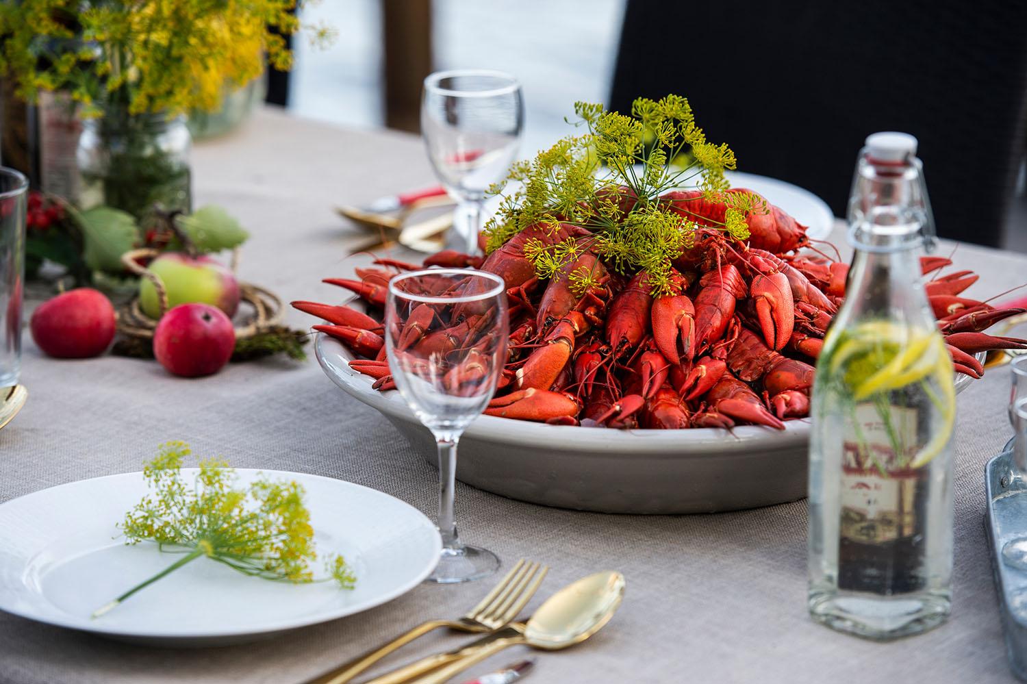 A plate full of crayfish on a dinner table.