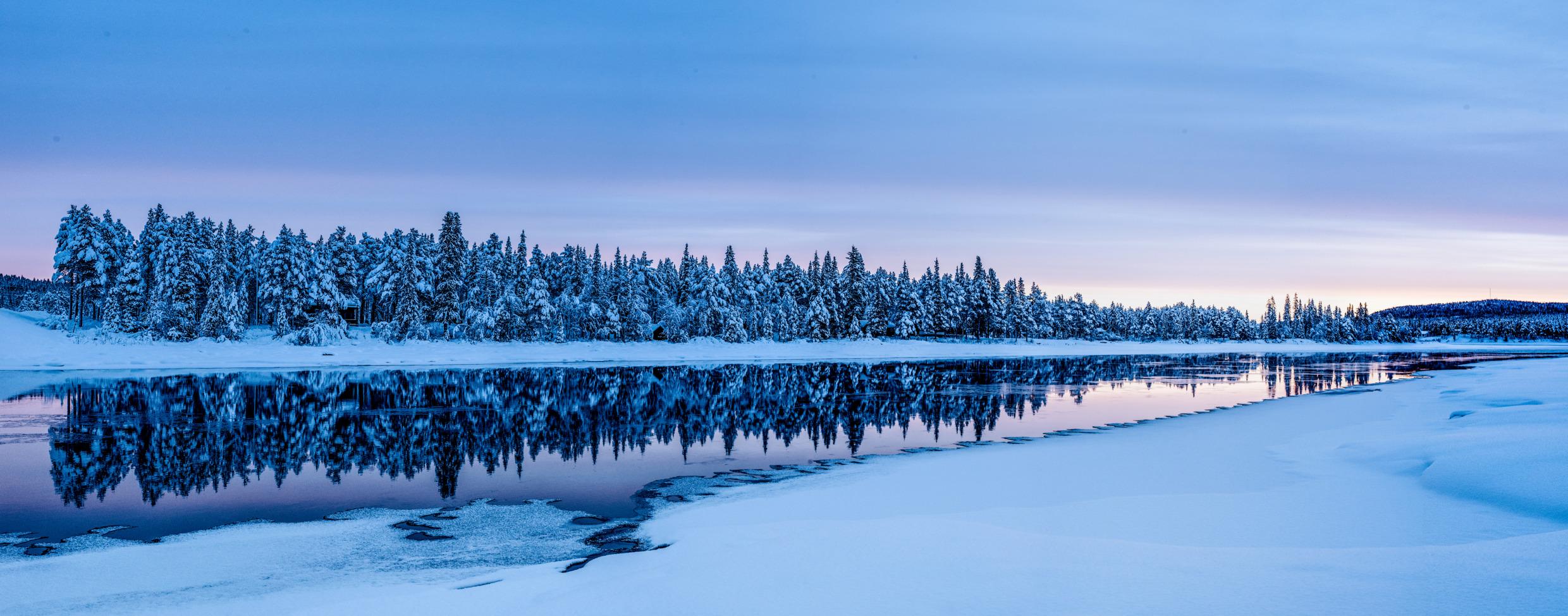 Torne river in winter, partly covered by ice.