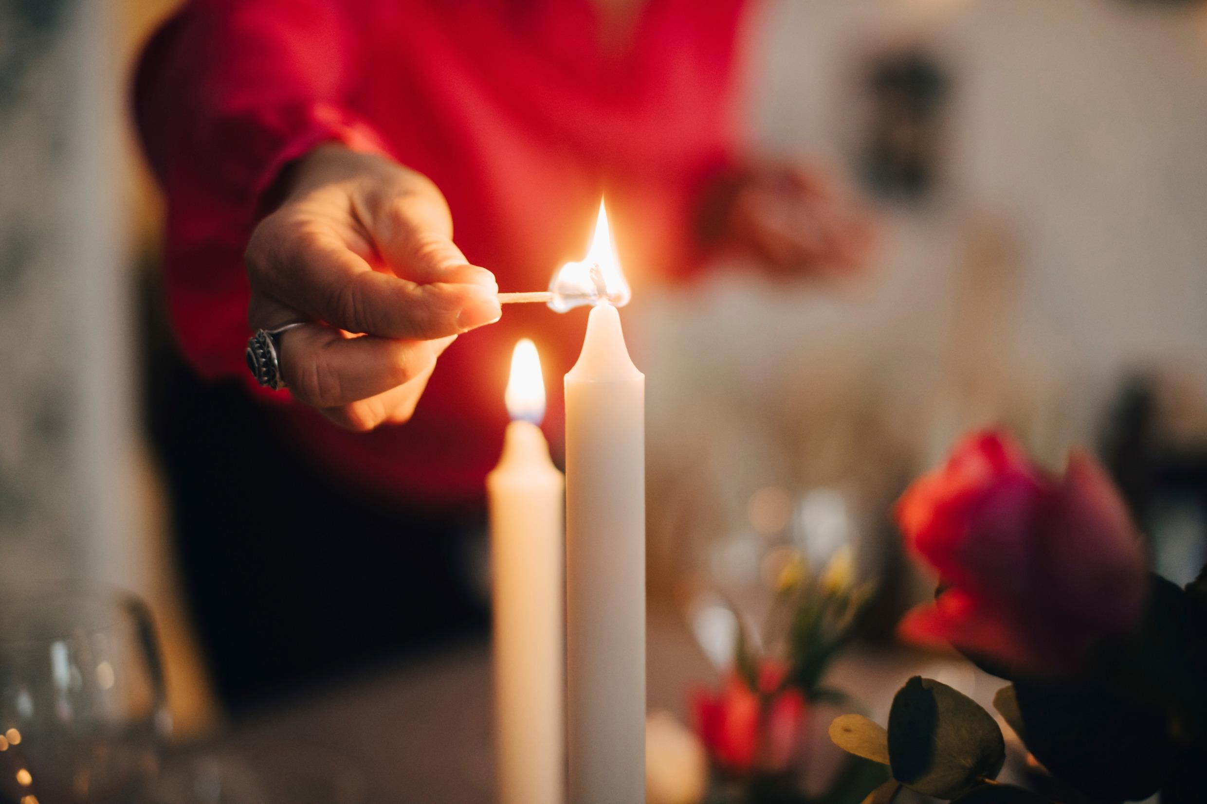 A person lighting candles.