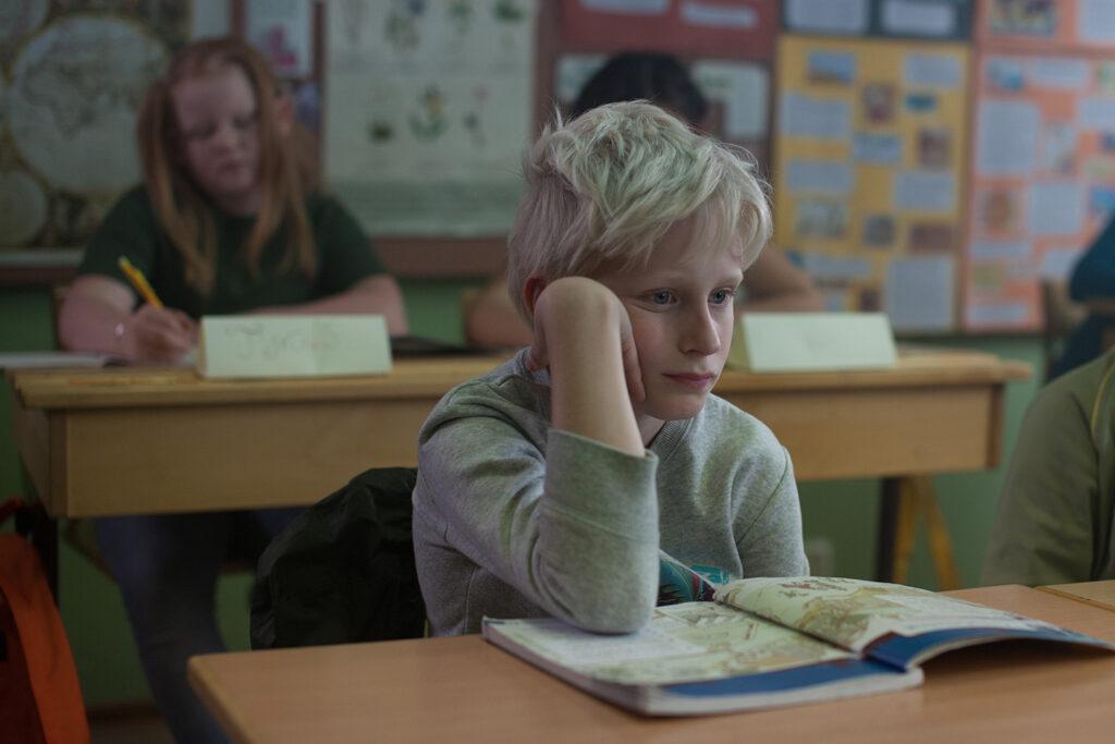 A boy in a classroom.