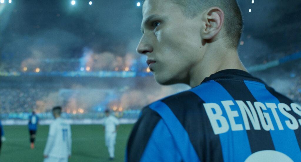 A young fotball player at an arena.