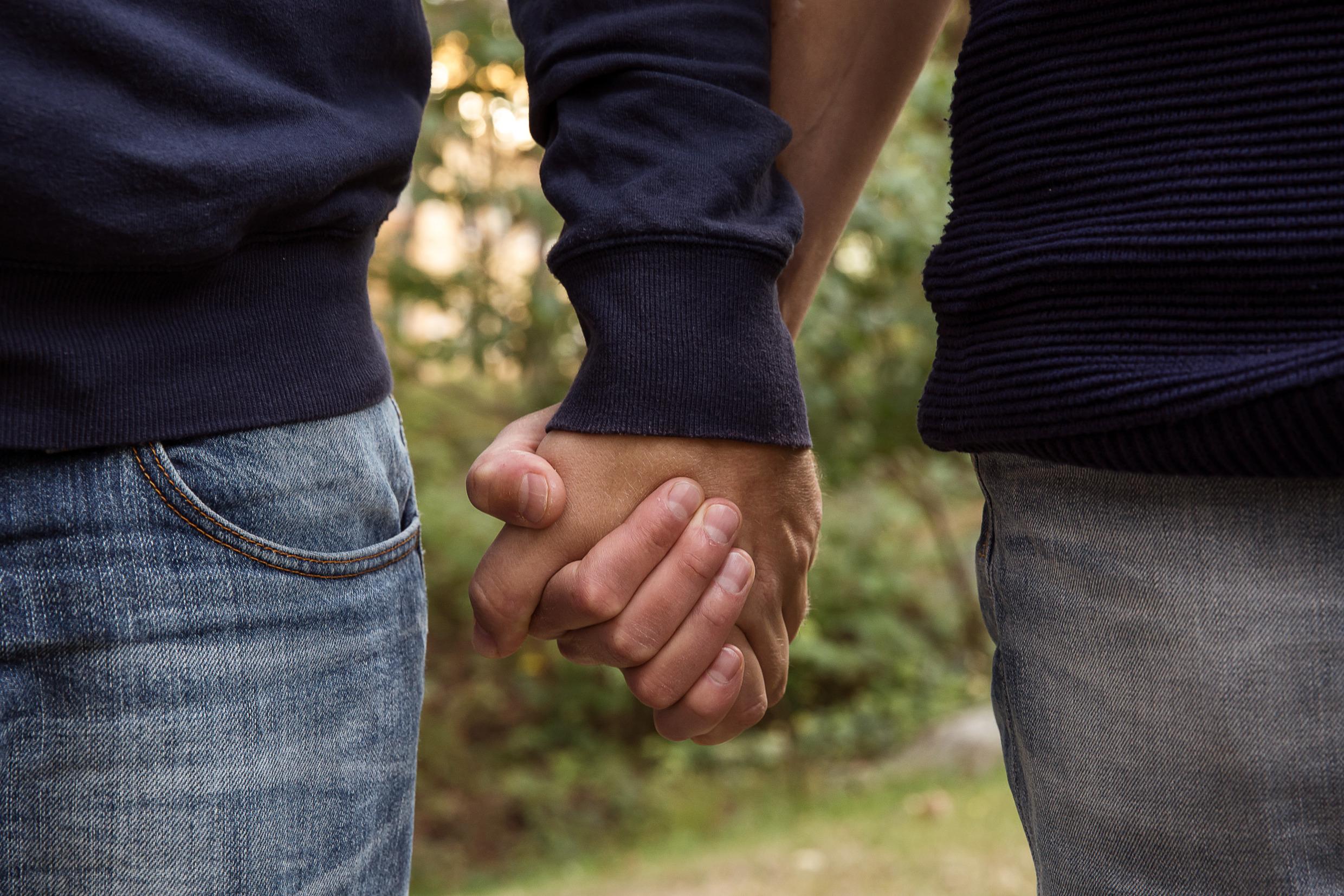 Two persons holding hands.