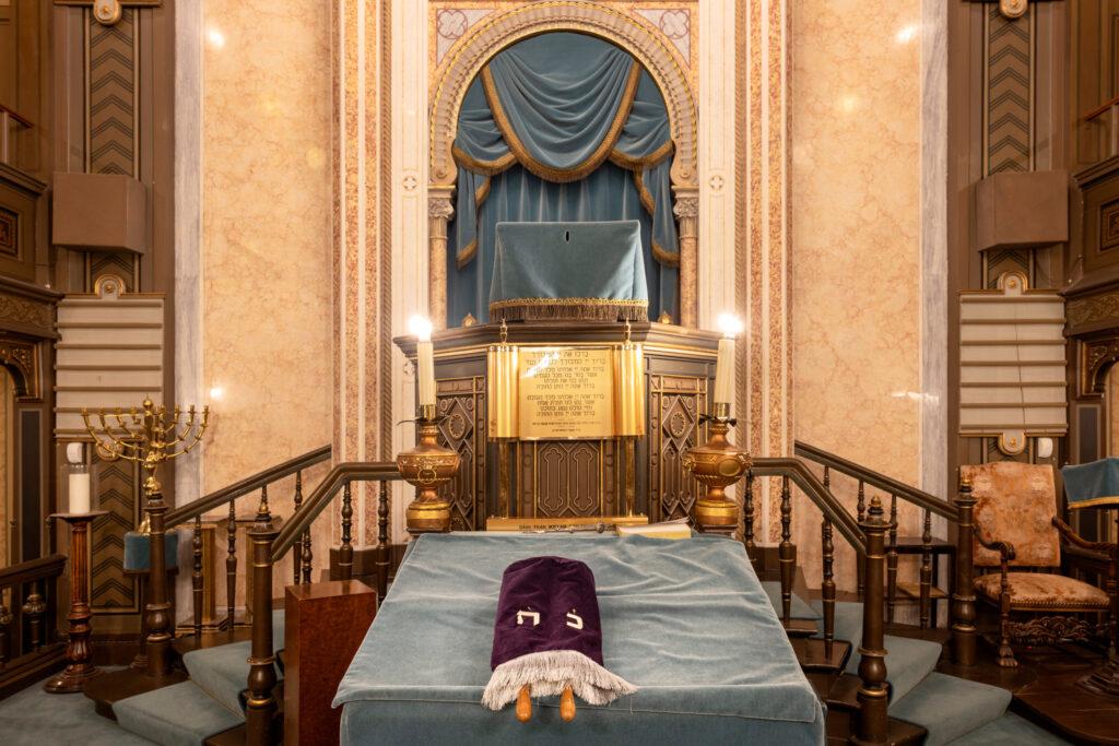 A Torah scroll lies in front of the altar in a synagogue.