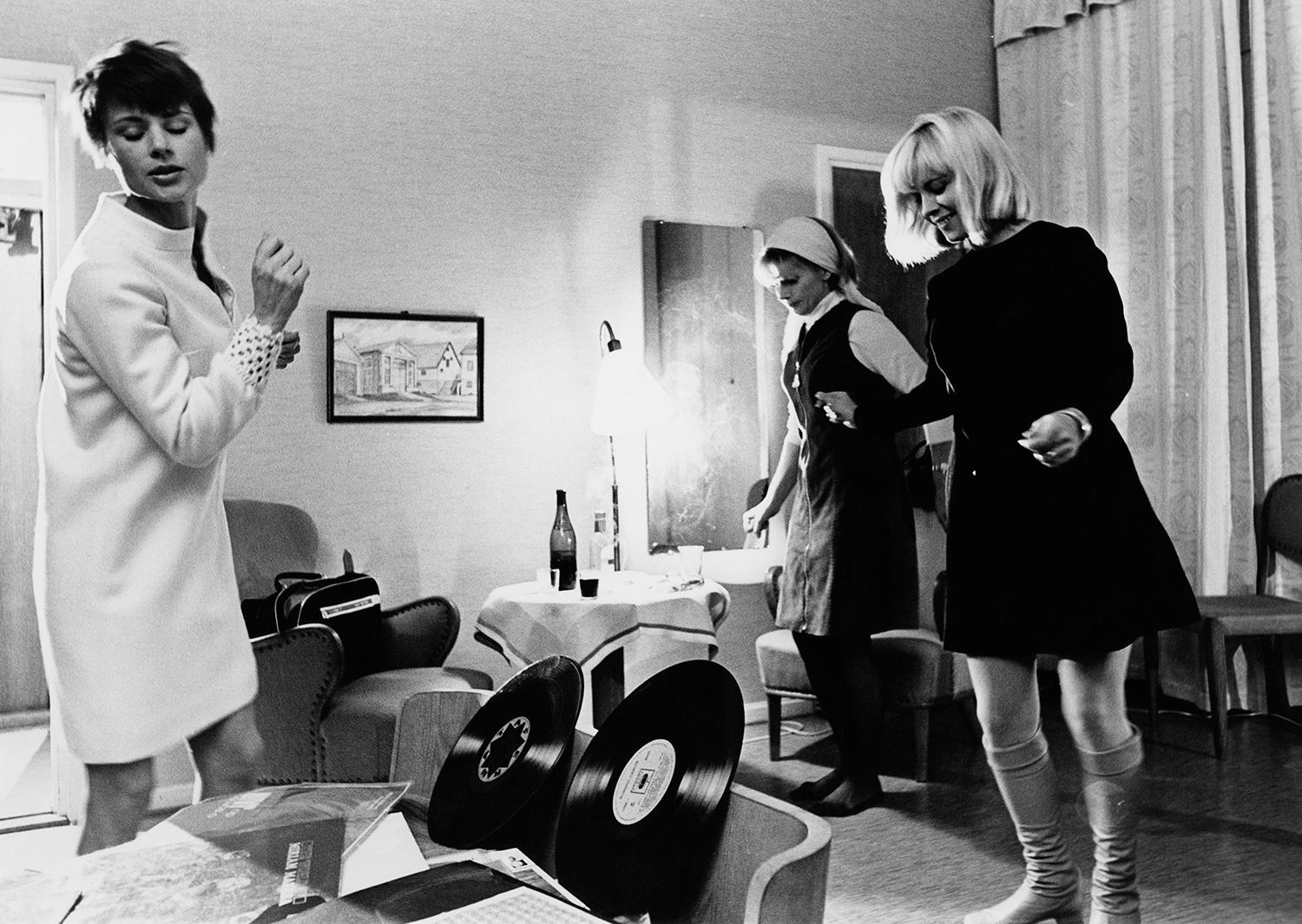 Three women in the 1960s dancing to music.