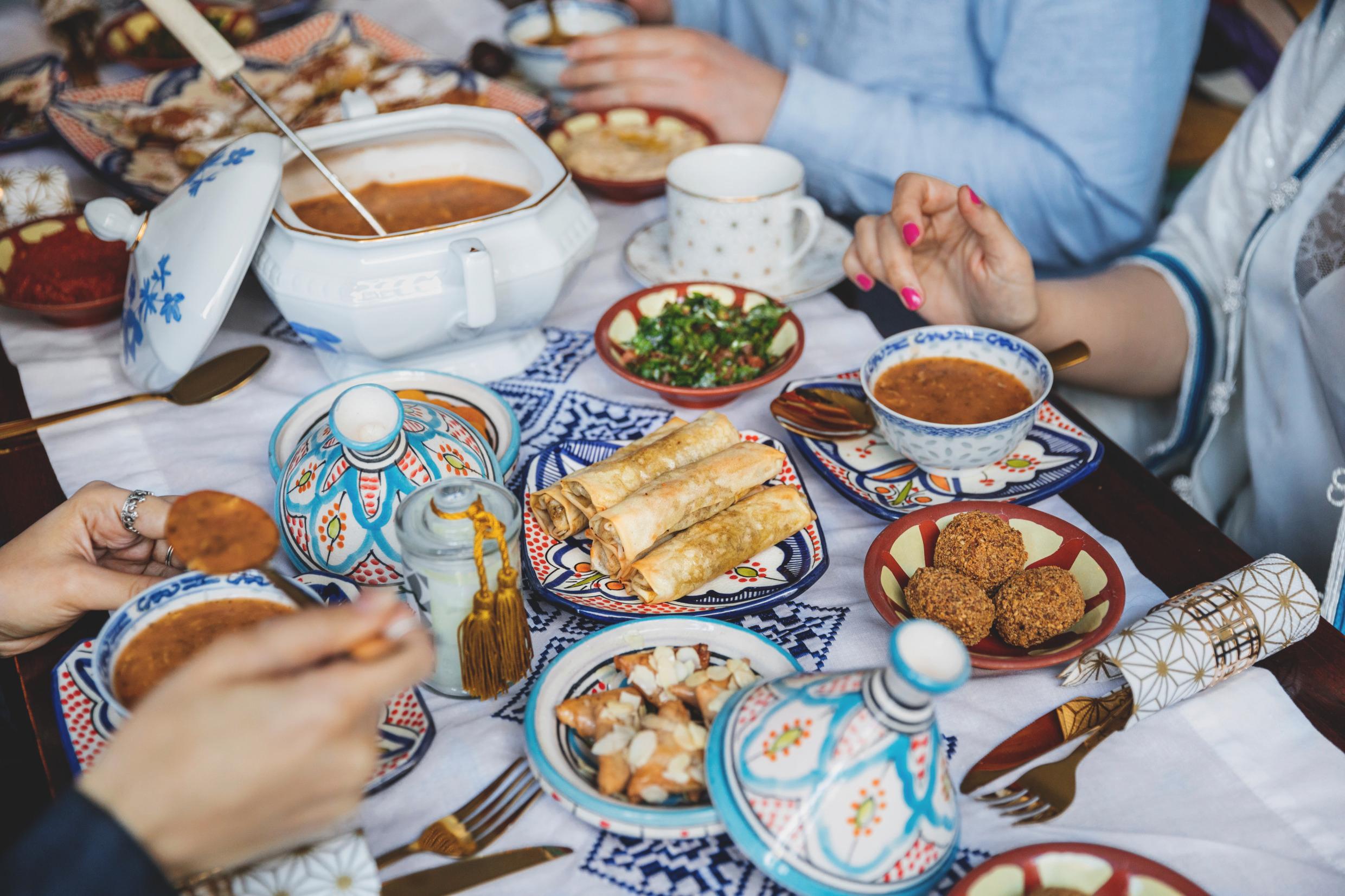 People around a food-filled table.