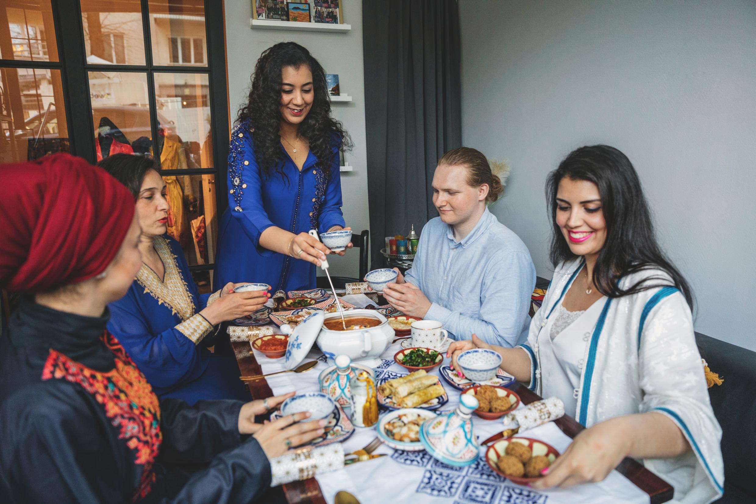 People around a food-filled table.