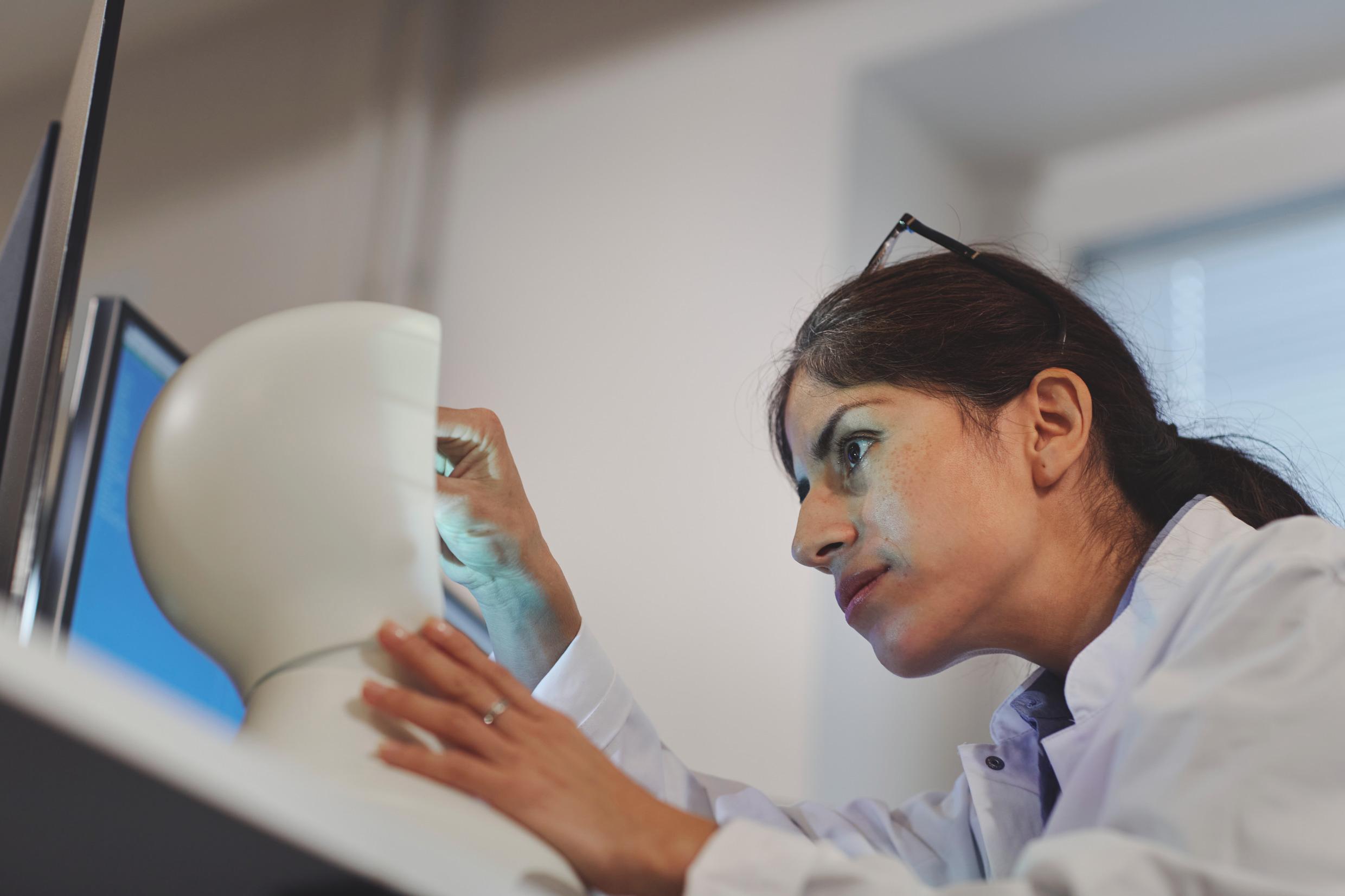 A woman working on a robot.