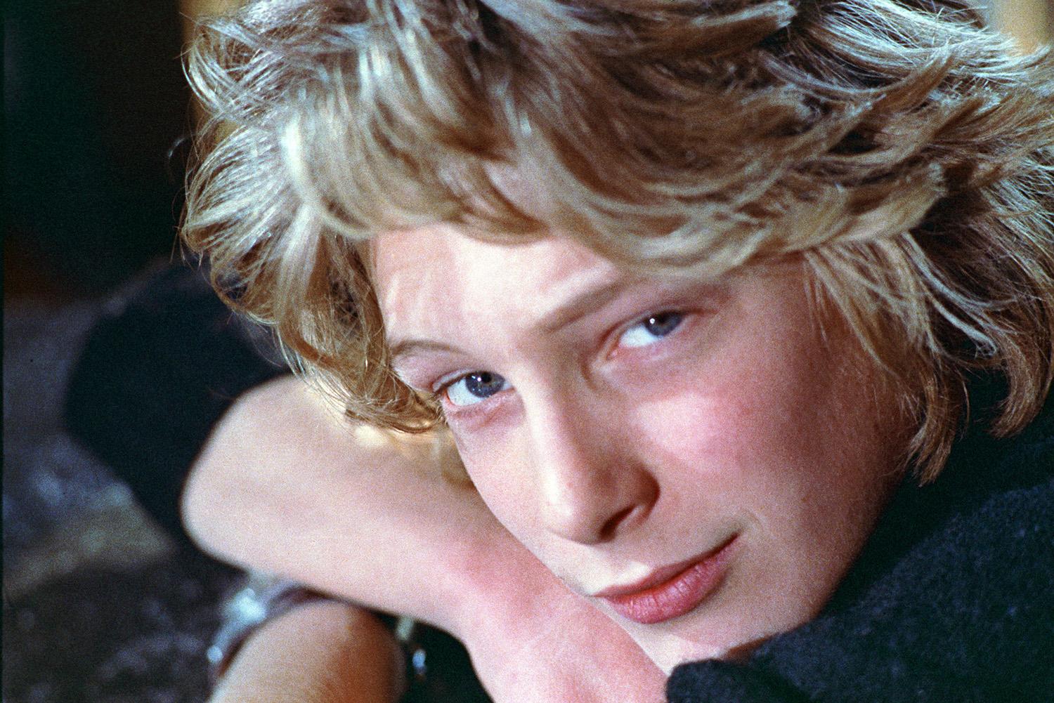 A blond teenage boy looking into the camera.