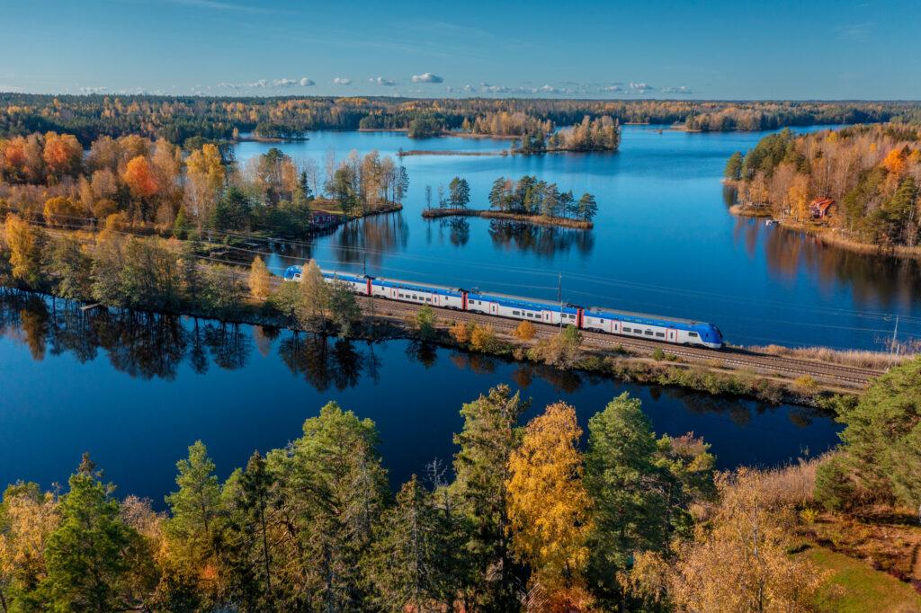 A train traveling over water in autumn