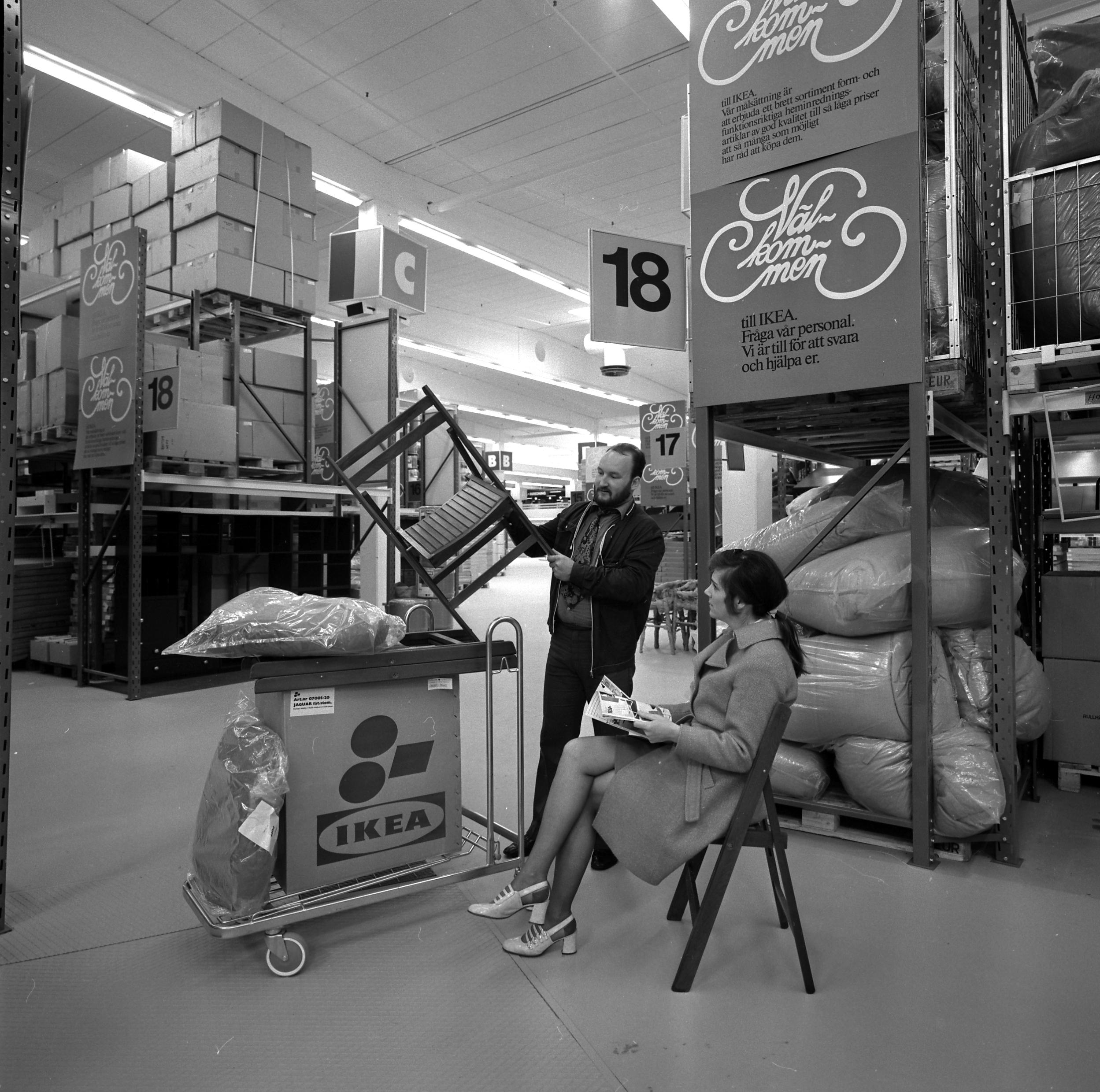 A couple in the sixties collecting furniture at IKEA.