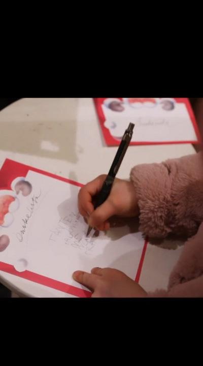 A child writing a letter to Santa.