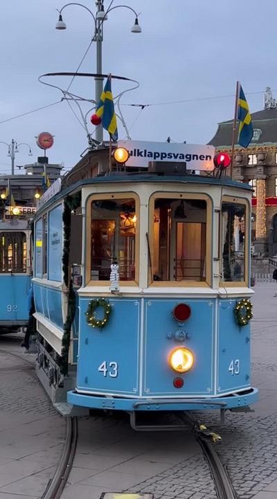 A blue tram with decorations on it