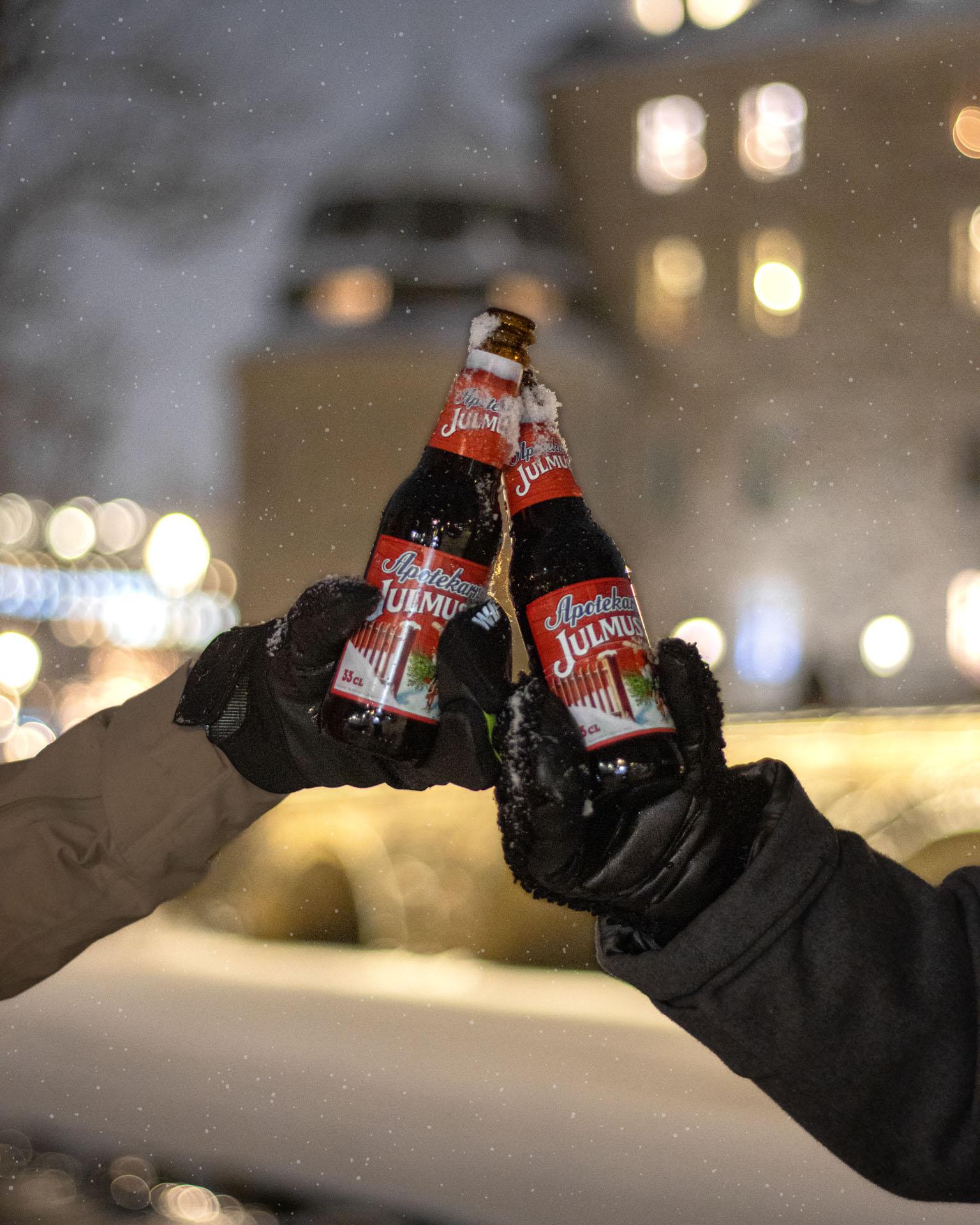 Two bottles of Julmust in a snowy Örebro.