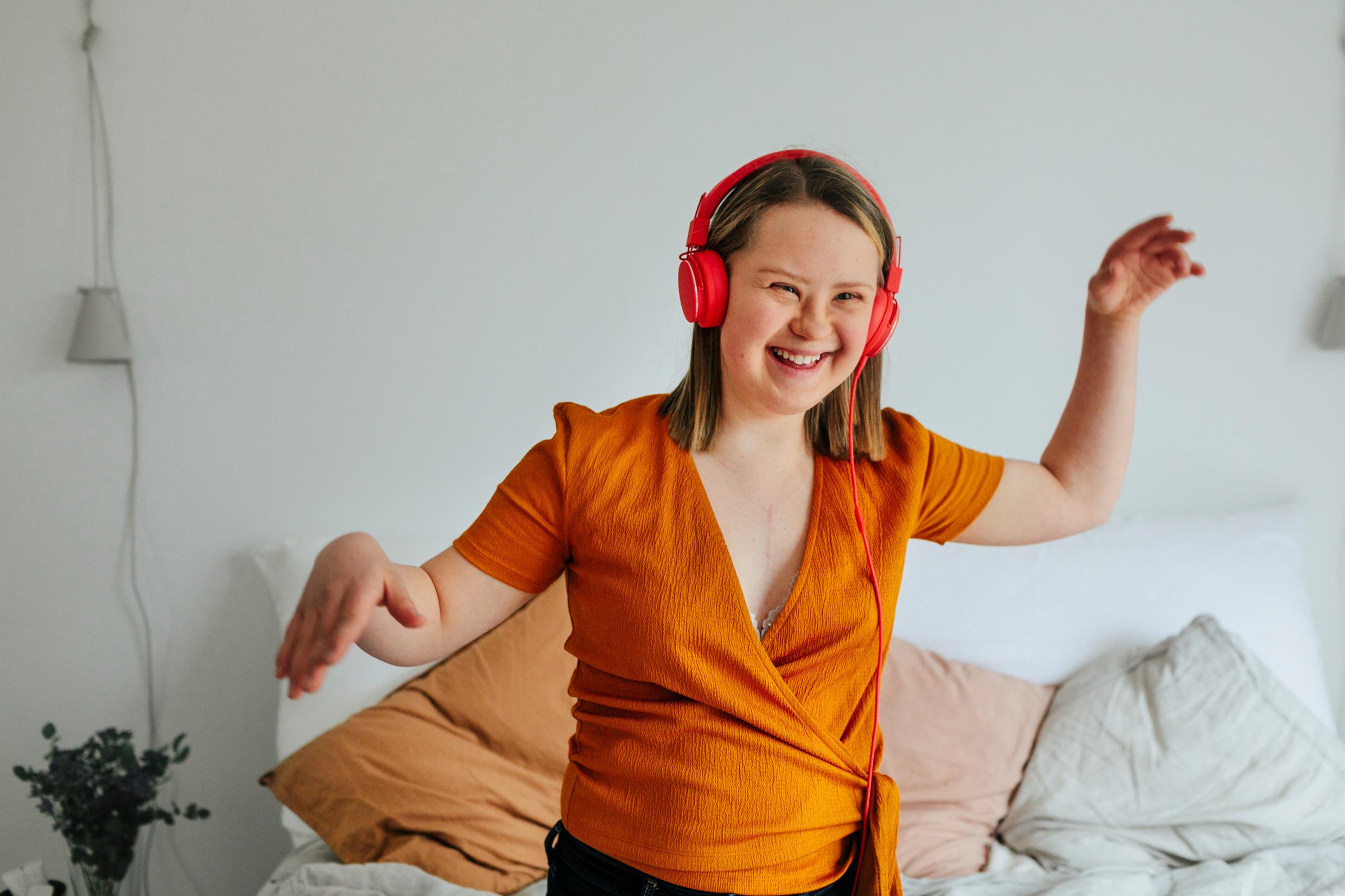 A young happy girl listening to music.