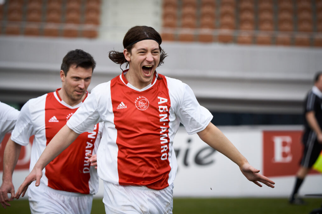 Football player in red and white clothing.