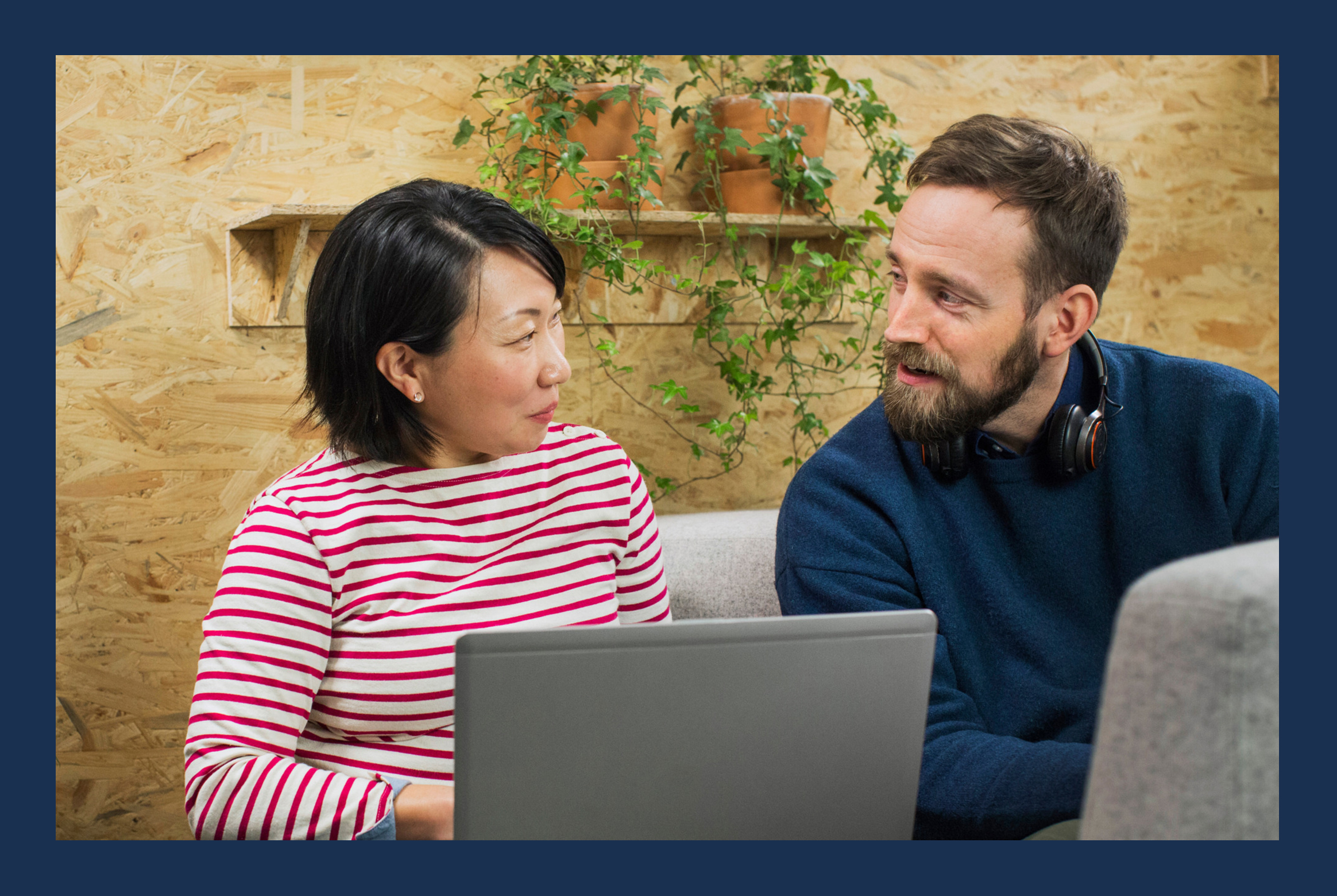 Two people working on their laptops.