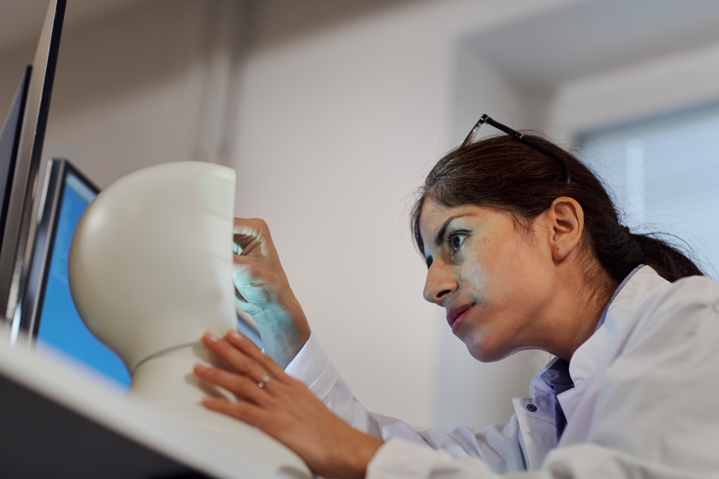A woman working on a robot.