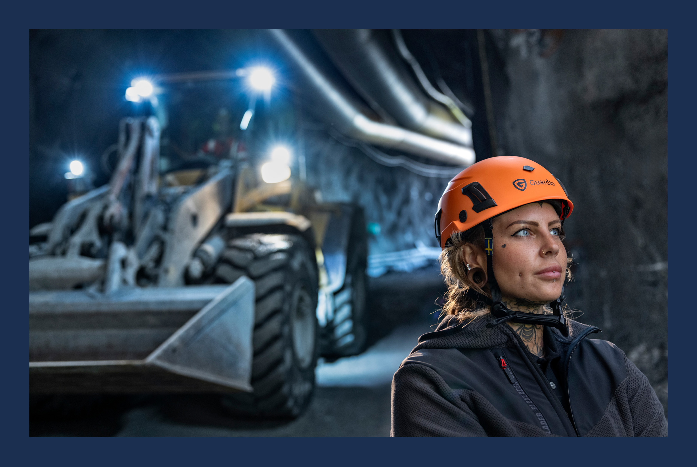 A woman with a helmet doing construction work.