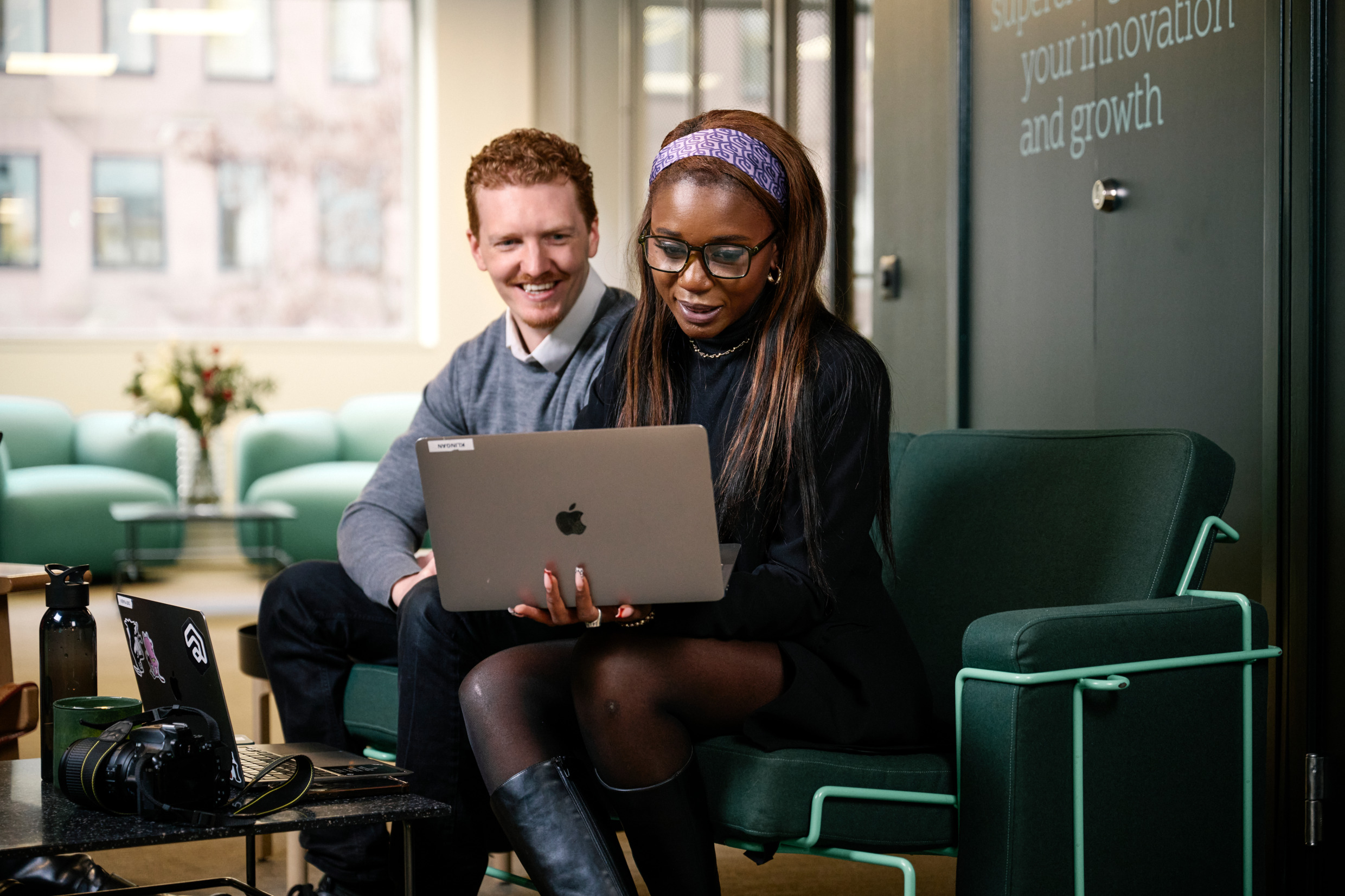 A man and woman working on laptops.