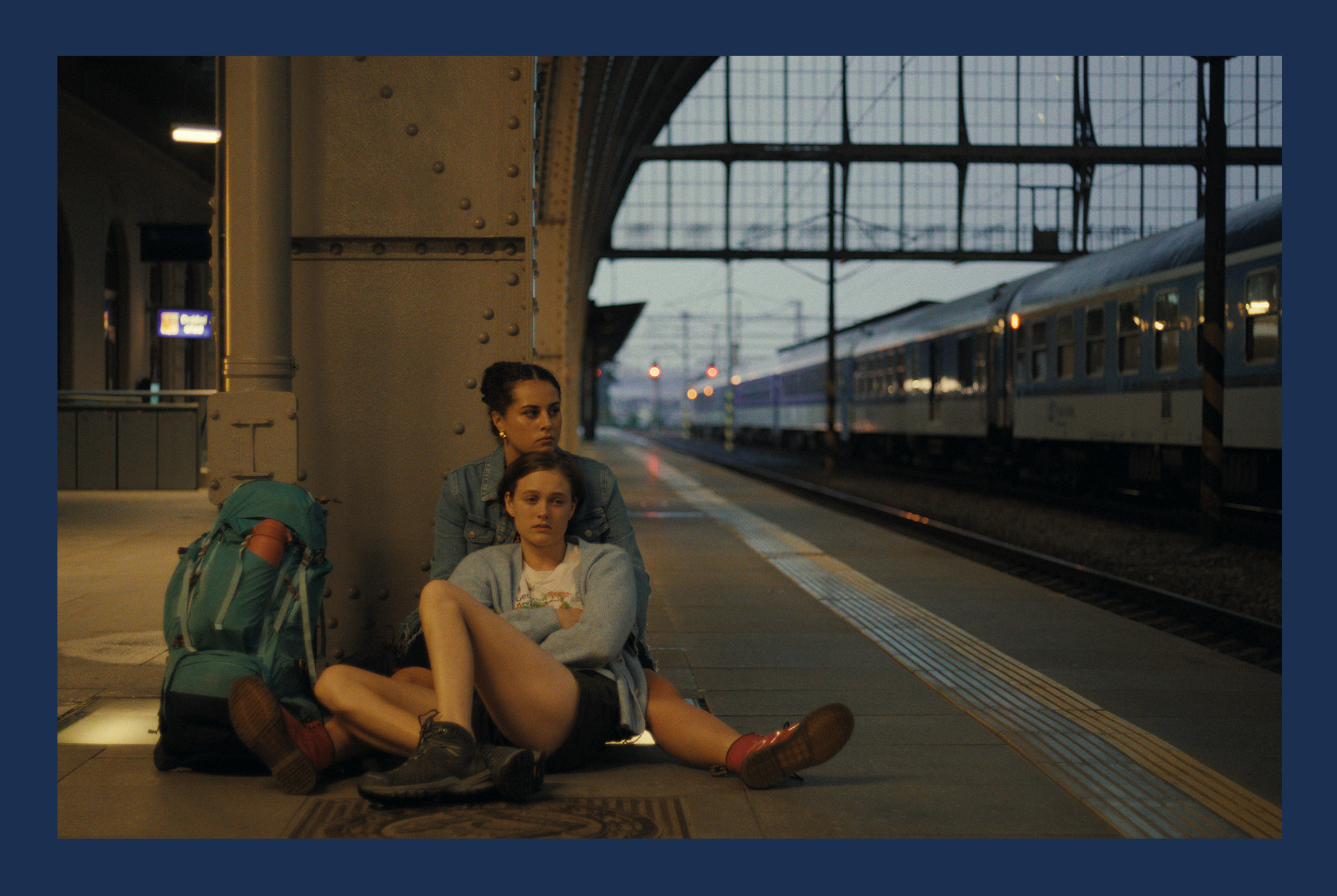 Two young women at a train station